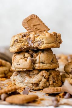 chocolate chip cookies stacked on top of each other with one cookie in the middle and two broken ones