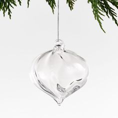 a glass ornament hanging from a christmas tree