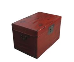 an old red wooden box with metal handles