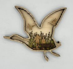 an image of a bird that is flying in the air with animals on it's back