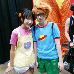 two people standing next to each other wearing costumes