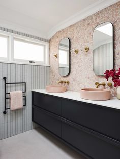 a bathroom with two sinks and mirrors in it