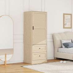 a bedroom with a bed, dresser and mirror on the wall next to an armoire