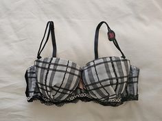 A NWT old stock Vintage Nylon and Lace Push Up Bra from Japan, in size 14A/Aus, 36A/UK and 36A/US, (Japanese C80) in a plaid/check chiffon finish on the cups with contrasting lace trim. Underwired and padded with elasticised, adjustable and removable straps and double clasp. Satin Bow between cups. Colour - Grey/Black Invisible Wardrobe, Vintage Bra, Bra Items, Satin Bow, Bra Lingerie, Push Up Bra, Push Up, Lace Trim, Gray Color