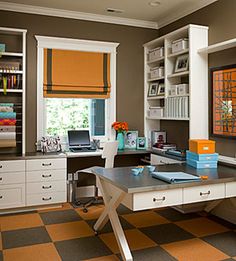 a home office with orange and white decor