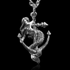 Dive into a world of enchantment with our Mermaid Silver Pendant Holding an Old Anchor. Crafted with exquisite detail, this captivating pendant features a graceful mermaid delicately holding onto an aged anchor, blending maritime charm with mythical beauty in a stunning piece of jewelry. The Treasure of the Sea - P61 Pendant Weight: 22 grams Silver Chain Weight: 15 grams to 24 grams  (18 inches to 30 inches long Italian Sterling Silver Cable Chain 1/8 inch Thick Platinum Plated). Pendant  Size: Anchor Pendant Gold, Siren Necklace, Mermaid Siren, Mermaid Pendant, Anchor Pendant, Mermaid Jewelry, Charm Necklace Silver, Jewelry Necklace, Cable Chain