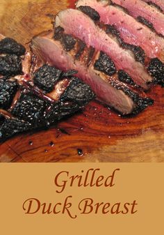 grilled duck breast on a wooden cutting board