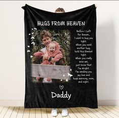 a woman holding a baby in front of a black blanket with the words hugs from heaven