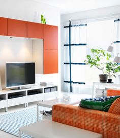 a living room filled with furniture and a flat screen tv