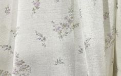 a white shirt with purple flowers on it