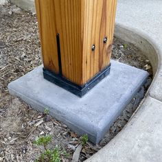 a wooden box sitting on top of a cement block