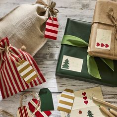 christmas presents wrapped in brown paper and tied with twine on top of a wooden table