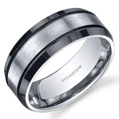 a men's wedding band with black and white ceramic inlays is shown