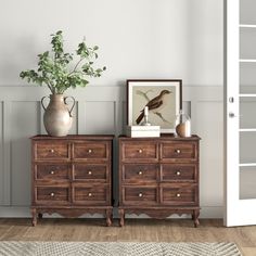 two wooden dressers sitting next to each other on top of a hard wood floor