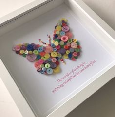 a white frame with buttons in the shape of a butterfly