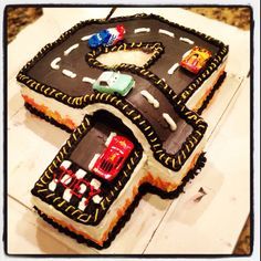 two cakes shaped like cars on top of each other with the letter e in the middle