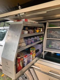 an open refrigerator in the back of a truck with food items on it's shelves