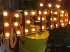 the word retro is lit up in front of a green bucket with lights on it