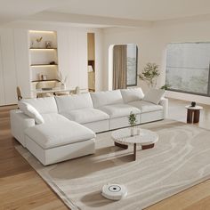 a living room with white furniture and wood flooring in front of a large window