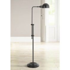 a black floor lamp in an empty room