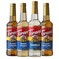 four bottles of torani torani classic vanilla flavored syrup on a white background