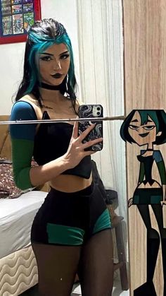 a woman with blue hair is taking a selfie in front of a mirror and holding a camera