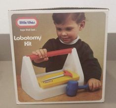 a little kid playing with a toy tool set in its box on the counter top