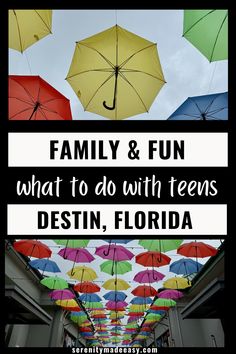 colorful umbrellas are hanging from the ceiling in front of a building with text overlay that reads family and fun what to do with teens, destin, florida