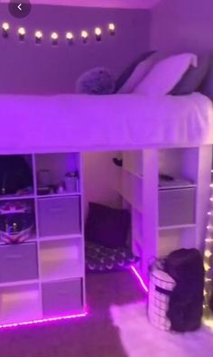 there is a loft bed with purple lights on the bottom and white drawers underneath it