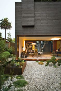 an outdoor living area with gravel and plants