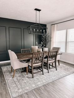 a dinning room table with chairs and a chandelier