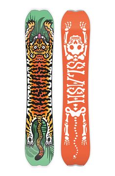 two snowboards with designs on them sitting next to each other