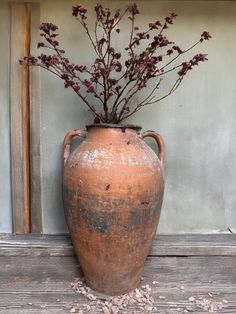 a large vase with some flowers in it