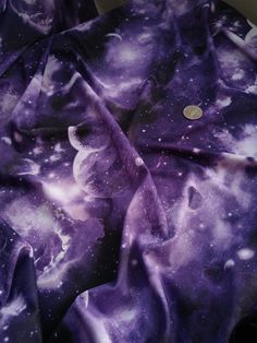 a purple and white tie dye shirt with space on it