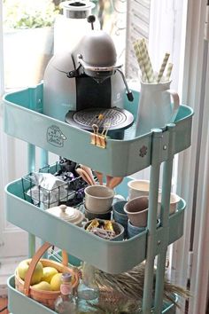 a three tiered tray with cups and bowls on it