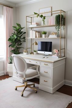 a white desk with a computer on it and some plants in the corner next to it