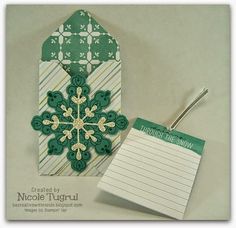 an ornament with a notepad attached to it next to a piece of paper