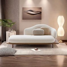 a white couch sitting on top of a wooden floor