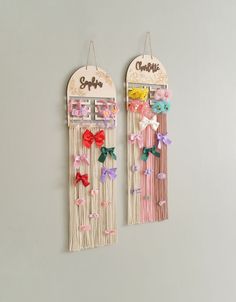 two wall hangings decorated with bows and name on them, one is made out of wood