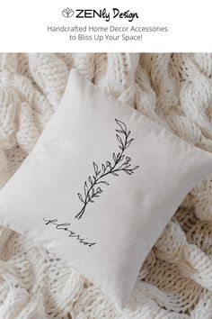 a white pillow sitting on top of a blanket