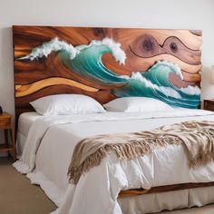 a large wooden headboard with an ocean wave painting on the wall next to it