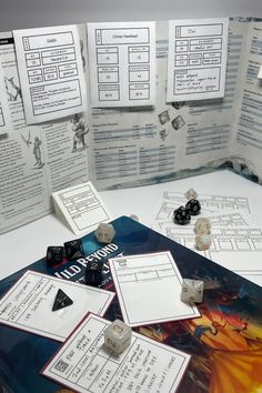 a game board with dices and instructions on the table next to it, as well as other pieces of paper