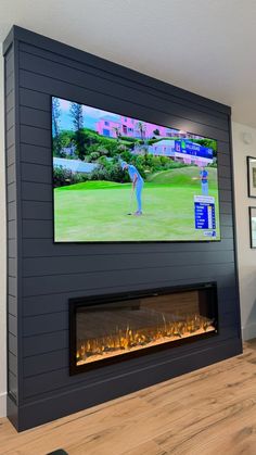 a flat screen tv mounted on the wall above a fireplace