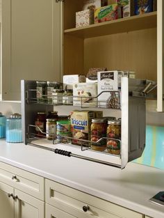 a kitchen counter with an open spice rack on it's side, filled with spices and condiments