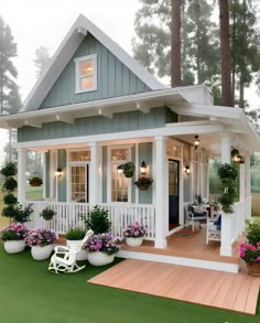 a small white house with porches and potted plants on the front lawn area