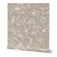 a beige and white flowered wall hanging