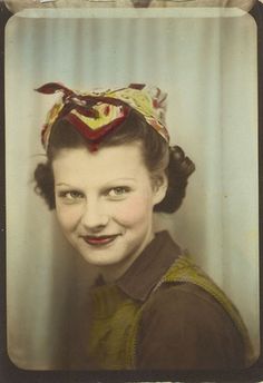 an old photo of a woman with a bow in her hair and a smile on her face