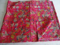 a pink and yellow patterned cloth laying on top of a white counter