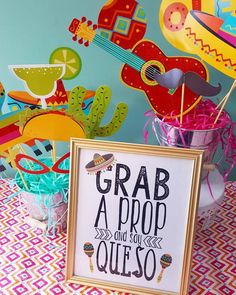 a sign that says grab a propo and say queso in front of some decorations