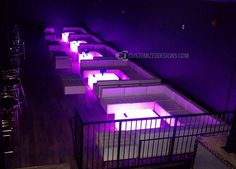 a row of beds with purple lights on them